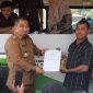 Pj Bupati Aceh Besar Muhammad Iswanto menyerahkan NIB kepada pelaku usaha yag mengurus izin usaha melalui mobil pelayanan perizinan keliling di halaman kantor Camat Blang Bintang, Kamis (7/9/2023).
