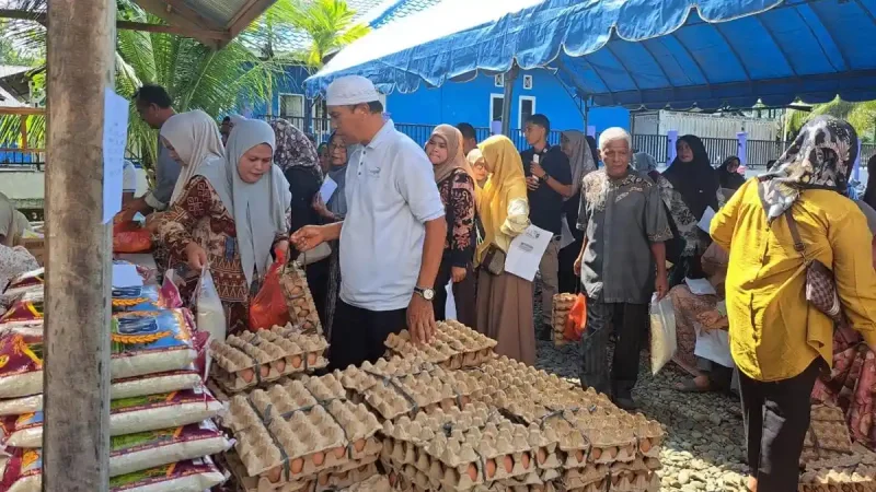 Warga Jantho Makmur mengantre membeli sembako pada kegiatan Gerakan Pangan Murah di halaman Kantor Camat Kota Jantho, Kamis (15/10/2026).